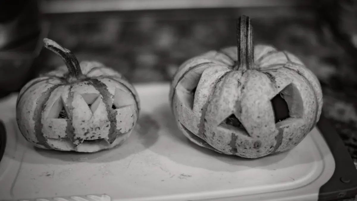 An open can of pumpkin puree beside a small jar of pumpkin powder and a measuring scoop