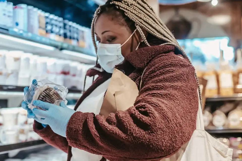 Owner reading a supplement label in a pet store aisle