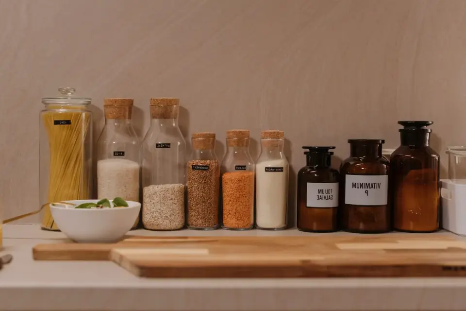 Several dog supplement bottles with different labels lined up on a kitchen counter