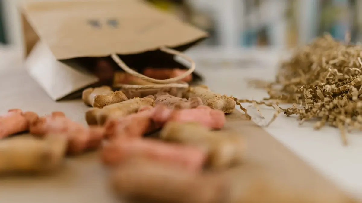 Small cubes of cheese sitting in an open treat pouch beside a dog on a leash